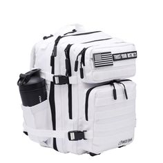 a white backpack with black straps and an american flag on the front, sitting against a white background