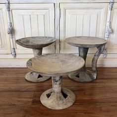 three wooden stools sitting on top of a hard wood floor