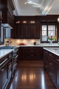 a large kitchen with dark wood cabinets and white counter tops, along with stainless steel appliances