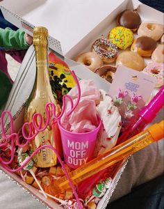 a box filled with lots of different types of doughnuts and other food items