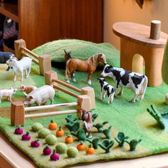 several farm animals are displayed on a table