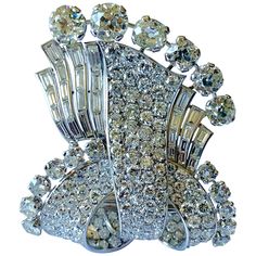 Exquisite Platinum und white gold brooch set with 6 old cut diamonds of approximately 9.00 ct, 28 Diamond baguettes of ca. 5.00 ct, 11 old european cut Diamonds of ca. 3.00 ct, and 129 pave set diamonds of ca. 10.00 ct. Dimensions ca. 5,8 x 4,9 cm. 1930s Brooch, Diamond Flower Brooch, Blue Sapphire Necklace, Art Deco Brooch, Gold Brooch, Diamond Brooch, Expensive Jewelry, Baguette Cut Diamond, Gold Brooches