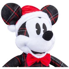 a mickey mouse stuffed animal with a red bow tie and hat on it's head