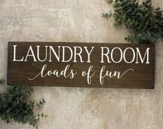 a wooden sign that says laundry room loads of fun