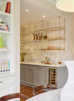 a kitchen with marble counter tops and shelves