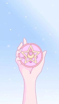 a person holding up a star in the air with their hand on top of it