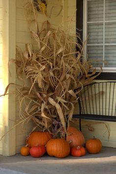 some pumpkins are sitting on the front porch