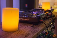 a table with a dj mixer and candles on it