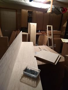 a room filled with lots of boxes and plywood boards on top of each other