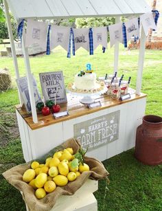 a table with lemons and strawberries on it at a farmer's market