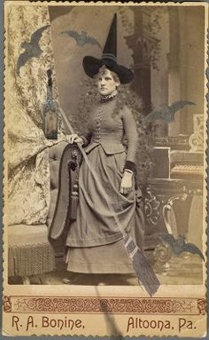 an old time photo of a woman dressed as a witch