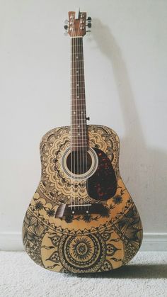 an acoustic guitar is sitting on the floor