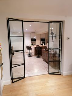 an open door leading to a kitchen and living room