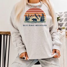 Welcome Friends, Expressive designs to gift wear and love. A beautiful retro sunset blue ridge mountains design. This retro sunset West blue ridge mountains crewneck sweatshirt is a pre-shrunk, a classic fit sweater that's made with air-jet spun yarn for a soft feel and reduced pilling. The design is screen printed onto a Gildan 18000 UNISEX Sweatshirt. This item ships within 3-7 days from the purchase date. See product images for the sizing chart. Blue Ridge Mountains Sweatshirt, Mountain Sweat Blue Vintage Tops For Outdoor, Retro Crew Neck Tops For Outdoor Activities, Mountains Design, Blue Ridge Mountain, Mountain Nature, Sunset Blue, Hiking Shirt, Welcome Friends, Retro Sunset