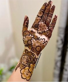 a woman's hand with henna on it