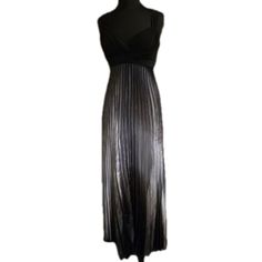 a black dress on a mannequin dummy with an open back and pleated skirt