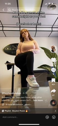 a woman sitting on top of a desk in front of a computer screen with the caption