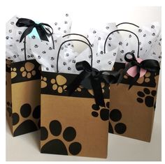 three brown bags with black and white paw prints on them