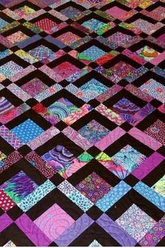 a quilt made with different colors and patterns