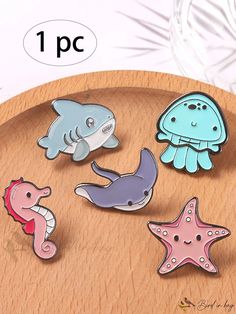 four different sea animals sitting on top of a wooden table