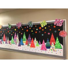 a bulletin board decorated with christmas trees and snowflakes on it's sides