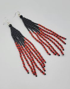 Those Beautiful Handmade pair of earrings were made by using size 6/0 black Miyuki seed beads,  round faceted beads, 4 mm bicones , silver plated ear wire. The earrings measure approximately 6 inches in total length  Thank you Black Beaded Earrings With Round Beads As Gift, Red Dangle Beaded Earrings With Colorful Beads, Elegant Red Earrings With Black Beads, Red Beaded Earrings With Black Round Beads, Adjustable Red Beaded Earrings With Black Beads, Black Faceted Bead Earrings For Gift, Black Faceted Beads Earrings For Gift, Red And Black Seed Bead Earrings, Red Faceted Beads Round Earrings