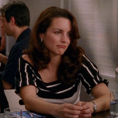 a woman sitting at a table in a restaurant