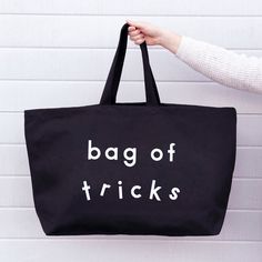 Our oversized canvas tote bags are the perfect huge holdalls for your day to day essentials and much more! Our REALLY big bags are REALLY useful. Perfect for the gym, the beach, weekends away and your weekly shop. Actually they are pretty handy for everything! Our 'Bag of Tricks' extra large bag has been made from thick black canvas, screen printed by hand big and bold in white. Lovingly stitched and printed in the UK. Hooray! Made in the UK 15oz thick black canvas Deep flat base Screen printed in white Mid-length handles 730mm by 440mm by 170mm (28¾ by 17½ by 6¾ inches) Mom Bag, Mom Bags, Buy Bags, Oversized Tote Bag, Oversized Tote, Big Bag, Big Bags, Tote Bag Leather, Large Tote Bag