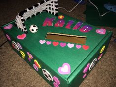 a cake shaped like a soccer field with the name kate written on it and decorations