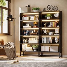 a living room filled with lots of furniture and bookshelves covered in lights next to a window