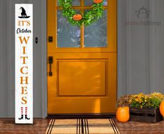 an orange front door with a welcome sign next to it