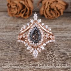 an image of a diamond ring on a wooden table with roses in the back ground