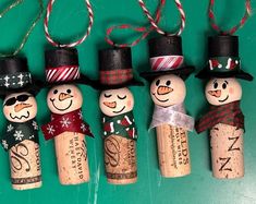 four wine cork snowmen with hats and scarfs