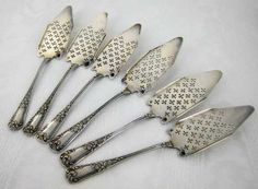 six antique silverplated serving utensils with star designs