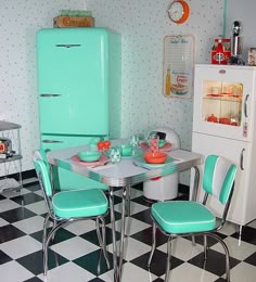 an old fashioned kitchen with retro appliances and checkered flooring, including a turquoise refrigerator