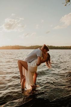 a man and woman kissing in the water