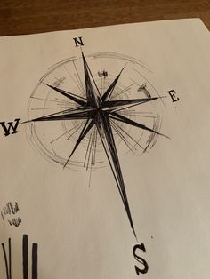 a black and white drawing of a compass