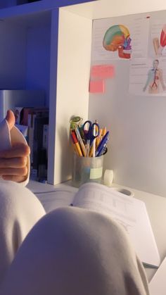 a person laying in bed with their back turned to the camera and holding an object