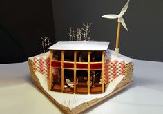 a model of a house with a wind turbine on top