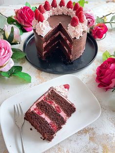 a piece of chocolate cake with raspberries on top and one slice missing from it