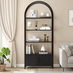 a living room with a couch, chair and bookcase in it's corner