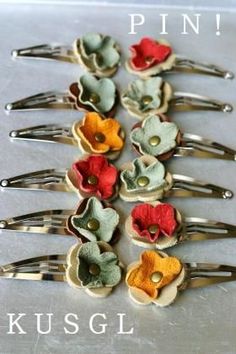 a bunch of hair clips with flowers on them