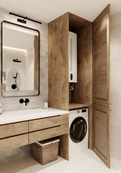 a washer and dryer in a bathroom with white tile on the walls, along with wooden cabinets