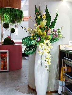 a large white vase filled with lots of flowers