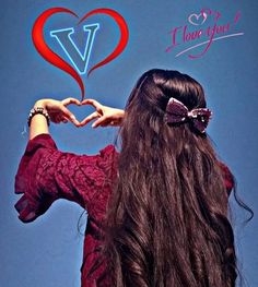 a woman with long hair making a heart shape with her hands and the words i love you above her