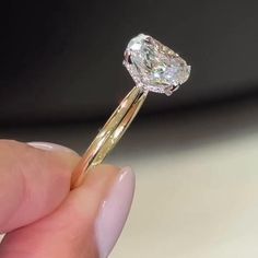 a close up of a person holding a diamond