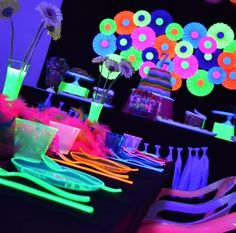 a table with neon lights and decorations on it