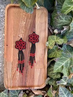 Matte Red Black Floral Earring, Huichol Earrings, Beaded Earrings, Dangling Flower Earrings, Cute Burgunfy Flower Earrings, Seed Bead Earrings ♥𝑇ℎ𝑒 𝑝𝑎𝑡𝑡𝑒𝑟𝑛 𝑜𝑓 𝑡ℎ𝑖𝑠 𝑒𝑎𝑟𝑟𝑖𝑛𝑔 𝑖𝑠 𝑐𝑟𝑒𝑎𝑡𝑒𝑑 𝑏𝑦 𝐾𝑎𝑍𝑒𝐵𝑒𝑎𝑑𝐽𝑒𝑤𝑒𝑙𝑟𝑦 ♥𝑀𝑎𝑑𝑒 𝑢𝑠𝑖𝑛𝑔 𝑓𝑟𝑒𝑒ℎ𝑎𝑛𝑑 𝑏𝑒𝑎𝑑𝑖𝑛𝑔 𝑤𝑜𝑣𝑒𝑛 𝑡𝑒𝑐ℎ𝑛𝑖𝑞𝑢𝑒𝑠 𝑤𝑖𝑡ℎ 𝑠𝑡𝑟𝑜𝑛𝑔 𝑠𝑦𝑛𝑡ℎ𝑒𝑡𝑖𝑐 𝑡ℎ𝑟𝑒𝑎𝑑. ♥𝑇ℎ𝑒 𝑠𝑖𝑧𝑒 𝑜𝑓 𝑡ℎ𝑒 𝑠𝑒𝑒𝑑 𝑏𝑒𝑎𝑑𝑠 𝑢𝑠𝑒𝑑 𝑖𝑠 2 𝑚𝑖𝑙𝑙𝑖𝑚𝑒𝑡𝑒𝑟𝑠 𝑎𝑛𝑑 𝑏𝑒𝑎𝑑𝑠 𝑎𝑟𝑒 ℎ𝑖𝑔ℎ 𝑞𝑢𝑎𝑙𝑖𝑓𝑖𝑒𝑑. ♥𝐴𝑙𝑙 𝑡ℎ𝑒 ℎ𝑜𝑜𝑘𝑠 𝑢𝑠𝑒𝑑 𝑖𝑛 𝑜𝑢𝑟 𝑗𝑒𝑤𝑒𝑙𝑟𝑦 𝑎𝑟𝑒 24 𝑘 𝑔𝑜𝑙𝑑 𝑝𝑙𝑎𝑡𝑒𝑑 𝑎𝑛𝑑 ℎ𝑦𝑝𝑜𝑎𝑙𝑙𝑒𝑟𝑔𝑒𝑛𝑖𝑐. ♥𝑇ℎ𝑒𝑠𝑒 𝑎𝑟𝑒 𝑣𝑒𝑟𝑦 𝑙𝑖𝑔ℎ𝑡 𝑒𝑎𝑟𝑟𝑖𝑛𝑔𝑠 𝑡ℎ𝑎𝑡 𝑦𝑜𝑢 𝑐𝑎𝑛 𝑤𝑒𝑎𝑟 𝑎𝑙𝑙 𝑑𝑎𝑦 𝑤𝑖𝑡ℎ𝑜𝑢𝑡 ℎ𝑢𝑟𝑡𝑖𝑛𝑔 𝑦𝑜𝑢𝑟 𝑒𝑎𝑟! The Red Beaded Flower Shaped Jewelry, Adjustable Red Flower Beaded Earrings, Traditional Red Earrings With Black Beads, Handmade Red Flower Beaded Earrings, Red Earrings With Black Beads As Gift, Red Earrings With Black Beads For Gift, Traditional Red Dangle Flower Earrings, Red Beaded Dangle Flower Earrings, Red Flower Beaded Earrings With Dangling Beads