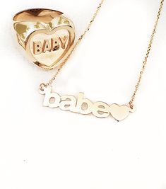 Babe♥ with a heart necklace designed for the love of your No matter how long you guys have been together, she should always be a babe for you! We'll design your beautiful Babe♥ necklace in or 14 k solid gold for her unconditional love for you, show it off always! This particular Babe♥ necklace was designed as a custom order for our lovely customer for the Valentine's day. Babe necklace is a perfect gift for: Birthday Mother's day Valentine's day Anniversary Christmas BFF or just to show love and Valentine's Day Yellow Gold Name Necklace, Valentine's Day Heart-shaped Name Necklaces, Gold Stainless Steel Name Necklace For Valentine's Day, Cheap Heart-shaped Name Necklace For Valentine's Day, Gold Metal Name Necklace For Valentine's Day, Word Necklace, Dainty Initial Necklace, Initial Necklace Gold, Pompano Beach