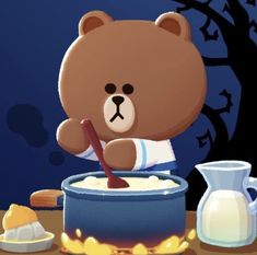 a brown teddy bear sitting in front of a bowl of food with a wooden spoon